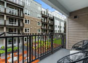 Thumbnail 37 of 43 - Balcony with Chairs at Solera Apartments, Renton, Washington
