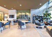 Thumbnail 3 of 32 - A modern living room with a grey sofa, a white coffee table, and a TV on a white wall.