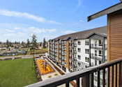 Thumbnail 10 of 21 - Exterior view of Kendrick Landing Apartments with playground in Lakewood, WA