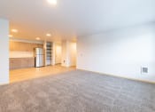 Thumbnail 8 of 25 - Spacious Living Room with Carpet and kitchen view