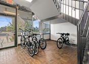 Thumbnail 24 of 46 - a group of bikes parked in a room next to a window