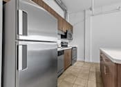 Thumbnail 2 of 46 - a kitchen with stainless steel appliances and wooden cabinets