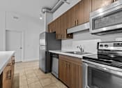Thumbnail 1 of 46 - a kitchen with stainless steel appliances and wooden cabinets