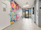 Thumbnail 29 of 46 - the hallway of a building with a colorful mural on the wall