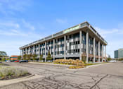 Thumbnail 44 of 46 - a large office building with a street in front of it