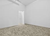 Thumbnail 13 of 46 - a bedroom with white walls and carpet and a door to a closet