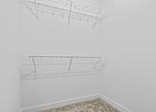 Thumbnail 14 of 46 - an empty closet in a room with white walls and a wire shelf on the wall