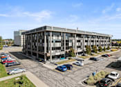 Thumbnail 45 of 46 - an aerial view of an office building with cars parked in a parking lot