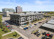 Thumbnail 43 of 46 - an aerial view of an office building with cars parked in a parking lot