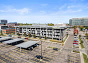 Thumbnail 40 of 46 - an aerial view of a parking lot in front of a large building
