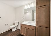Thumbnail 27 of 43 - a bathroom with a sink toilet and a mirror