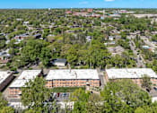 Thumbnail 28 of 30 - A bird's eye view of a residential area with apartment buildings and trees.