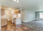 Thumbnail 1 of 34 - A kitchen with white appliances and wooden cabinets.