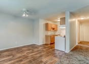 Thumbnail 5 of 34 - A kitchen area with a white refrigerator and wooden flooring.