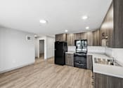 Thumbnail 27 of 54 - A modern kitchen with wooden cabinets and a black refrigerator.
