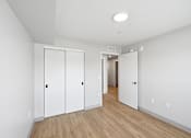 Thumbnail 50 of 54 - A hallway with a white door and a white wall.