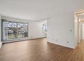 Thumbnail 30 of 37 - A room with wooden floors and white walls.