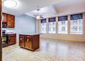 Thumbnail 42 of 52 - A kitchen with a marble floor and wooden cabinets.