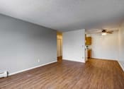 Thumbnail 21 of 34 - A room with wooden floors and white walls.