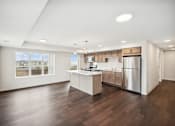 Thumbnail 10 of 43 - the preserve at ballantyne commons spacious living room and kitchen with stainless steel appliances