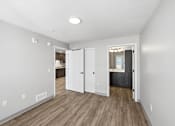 Thumbnail 31 of 54 - A room with a white wall and a wooden floor.