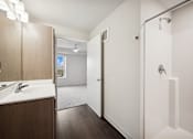 Thumbnail 33 of 43 - a bathroom with a shower and a sink and a mirror