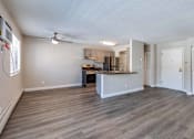 Thumbnail 2 of 31 - A spacious kitchen with a bar area and a ceiling fan.