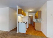 Thumbnail 30 of 34 - A kitchen with white appliances and wooden cabinets.