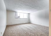 Thumbnail 25 of 34 - A room with a window and carpeted floor.