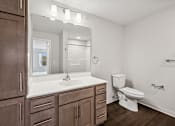 Thumbnail 7 of 43 - a bathroom with a toilet and a sink in it