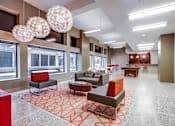 Thumbnail 2 of 52 - A spacious living room with a red and grey patterned carpet.