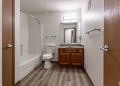 Thumbnail 21 of 38 - A small bathroom with a toilet, sink and a mirror.