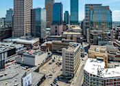 Thumbnail 51 of 52 - A cityscape with tall buildings and a clear sky.
