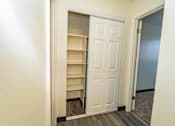 Thumbnail 20 of 34 - A white door is open to a room with shelves.