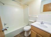 Thumbnail 4 of 34 - A white toilet sits next to a white sink in a bathroom.