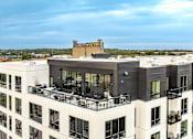 Thumbnail 81 of 85 - a view of a building with a balcony and a city in the background