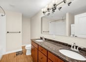 Thumbnail 20 of 68 - a bathroom with two sinks and a mirror and a toilet