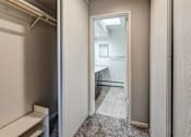 Thumbnail 31 of 66 - a hallway with a closet and a bathroom with a sink and a mirror