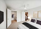 Thumbnail 6 of 43 - a bedroom with a bed and a ceiling fan