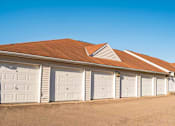 Thumbnail 12 of 34 - A row of white garage doors are closed.