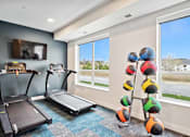 Thumbnail 37 of 43 - a gym with two treadmills and a tv on the wall