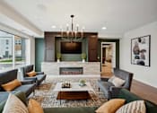Thumbnail 36 of 43 - a living room with couches and chairs and a fireplace