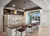 Thumbnail 13 of 43 - a large kitchen with a long island with chairs