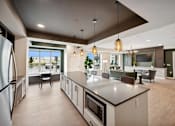 Thumbnail 3 of 43 - a large kitchen with a center island and a living room
