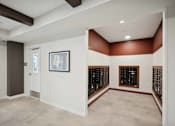 Thumbnail 39 of 43 - a tasting room with a wall of wine racks and a door to a cellar