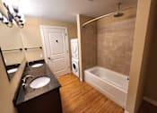 Thumbnail 32 of 68 - a bathroom with a sink and a tub and a washing machine