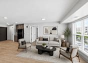 Thumbnail 3 of 54 - A modern living room with a grey sofa, a wooden coffee table, and a large window.