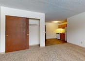 Thumbnail 26 of 34 - A room with a brown door and a white wall.