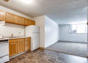 Thumbnail 17 of 34 - A kitchen with white appliances and wooden cabinets.