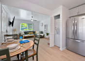 Thumbnail 4 of 16 - A modern kitchen with a dining table set for two.